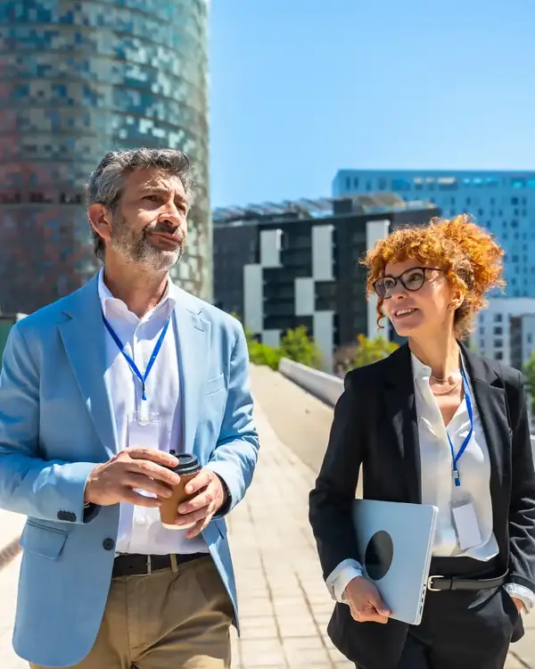 Duas pessoas a conversar sobre um projeto, num espaço urbano